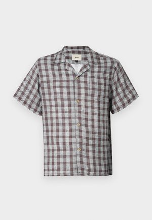 Short-sleeve brown and white plaid button-up shirt with camp collar and chest pocket on a plain background.