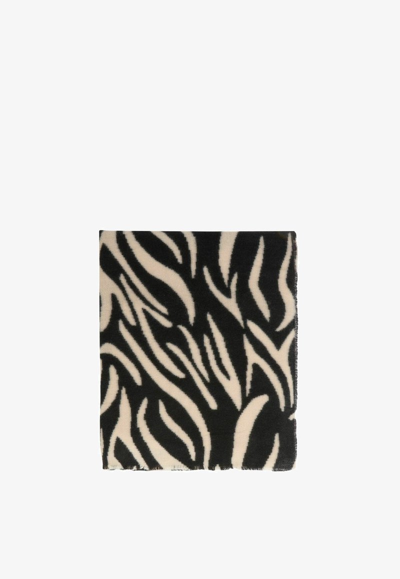 Coperta nera e crema con un audace motivo astratto a zebra. Tessuto morbido con bordi frangiati. Forma quadrata.