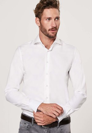 White long-sleeve dress shirt, smooth cotton fabric, buttoned front, pointed collar, fitted cut, and single-button cuffs.