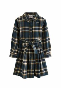 Flanellklänning i mörkblått med gul, röd och vit rutigt mönster. Har en knapp-down framsidan, krage och ett bälte att knyta vid midjan.