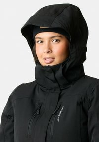 Black waterproof jacket with a high collar and large hood, featuring two zipped front pockets and a logo on the chest. Smooth texture.