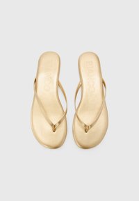 Kuldse flip-flops sileda tekstuuriga, peente rihmadega ja minimalistliku disainiga. Brändi logo "BIANCO" on peadpuidel<td>.