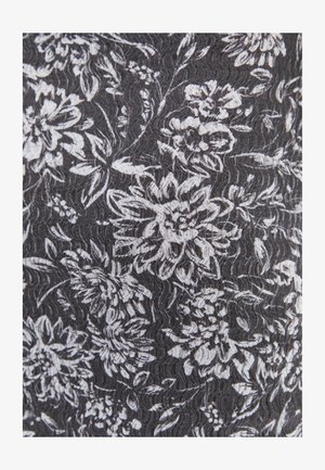 Tejido negro con un patrón floral blanco, texturizado con un sutil efecto ondulado, que muestra intrincados diseños de flores y formas orgánicas.