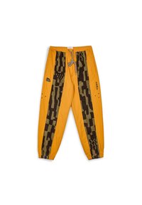 Orange pants with a textured brown pattern along the sides. Elastic waistband with drawstring and logo detail on the front.