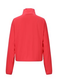 Red lightweight jacket with a high collar, long sleeves, and perforated side panels. Smooth texture, cropped design, suitable for active wear.