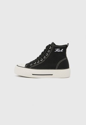 Black high-top canvas sneaker with white stitching, rubber toe cap, and a textured white sole. "Karl" embroidered on the outer side.