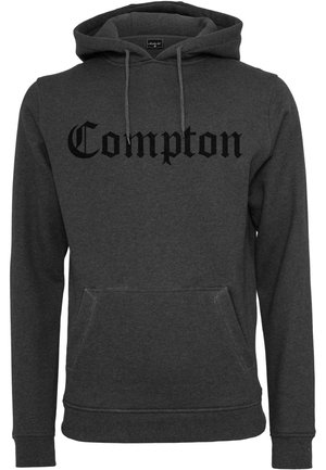 Mørkegrå hettegenser i et mykt stoff har en frontlomme og svart "Compton"-tekst i en dristig, stilisert font.