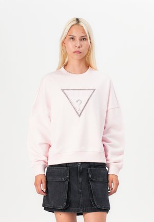 Rode sweatshirt met ronde hals, losse pasvorm en een driehoekige strassaccent op de voorkant. Draag met een zwarte spijkerrok.