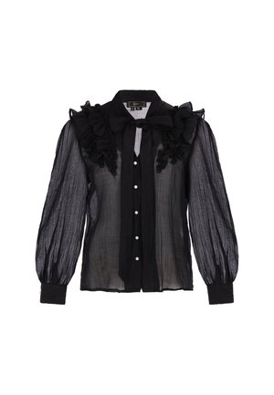 Blusa nera trasparente con colletto arruffato, lunghe maniche a sbuffo e chiusura frontale con bottoni simili a perle. Tessuto strutturato.