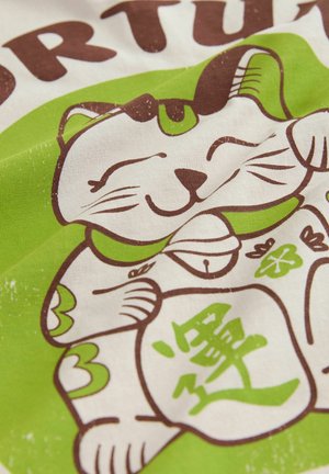 White fabric featuring a cartoon cat with a smiling face, green accents, and brown outlines, holding a sign with Japanese characters.