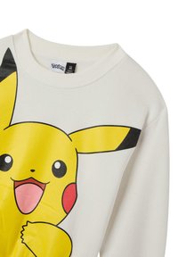 Felpa bianca con una grande grafica di Pikachu gialla e vivace, con accenti neri sulle orecchie, realizzata in morbido cotone.