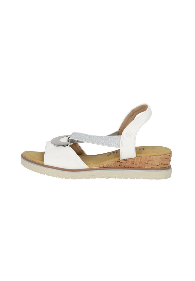 White wedge sandal with a cork heel, featuring a silver circular accent and a soft grey elastic strap. Smooth leather and textured insole.