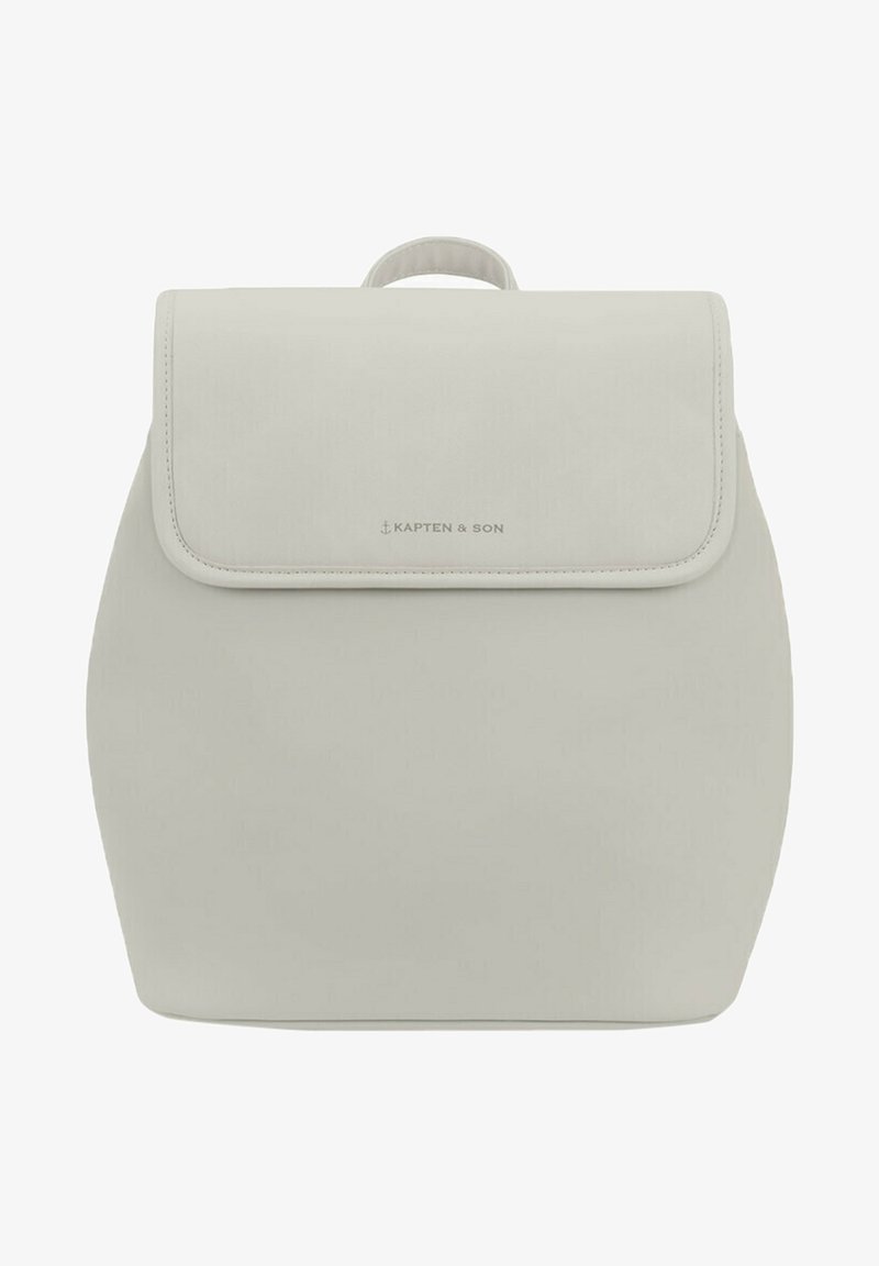 Světle šedý batoh s klopou, zaobleným tvarem a horním držadlem. V dolní části má jemné logo. Hladký povrch.