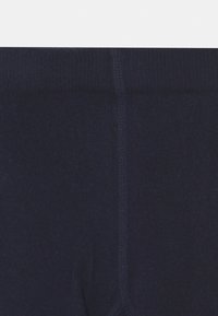 Leggings bleu marine fabriqués à partir d'un tissu doux et extensible. Dispose d'une taille large et d'une texture lisse avec des coutures renforcées.