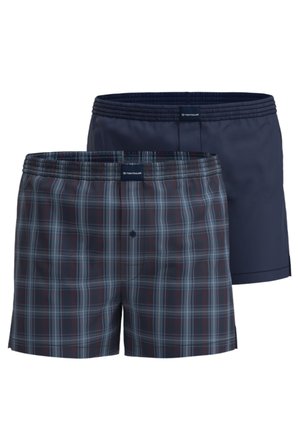 Two pairs of men's boxer shorts, one navy blue and one dark plaid with blue and red lines, both with elastic waistbands and a brand label.