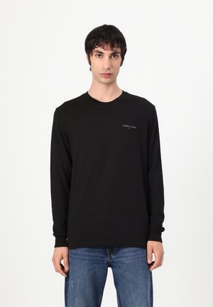Zwart long-sleeve t-shirt van katoen, met een ronde hals, een fitted silhouette en een klein wit logo op de linkerborst.