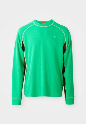 Long-sleeve green athletic shirt with textured fabric, contrasting brown side accents, and white stitching along the collar and seams.