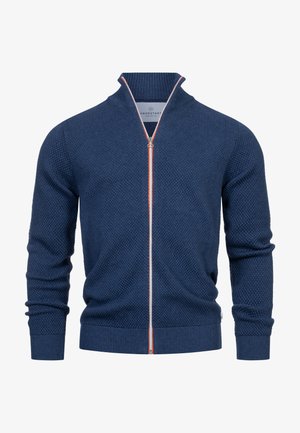 Gebreide ritsvest in donkerblauw met een gestructureerd patroon, contrasterende oranje en grijze rits, en geribbelde mouwen en onderkant.