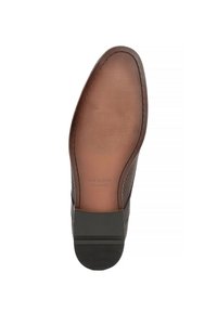 Suola di scarpa in pelle marrone con una finitura liscia, caratterizzata da una trama scanalata, un'etichetta con logo e un design con bordo arrotondato.