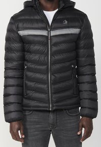 Black puffer jacket, quilted design with horizontal grey stripe, zip closure, adjustable hood, two side pockets, smooth texture.