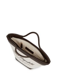 Kangasostukot, tumepruunist nahkakätkest, kreemivärviline keha musta tekstiga, tõmblukuga sulgus ja beež riidest interjöör taskuga.