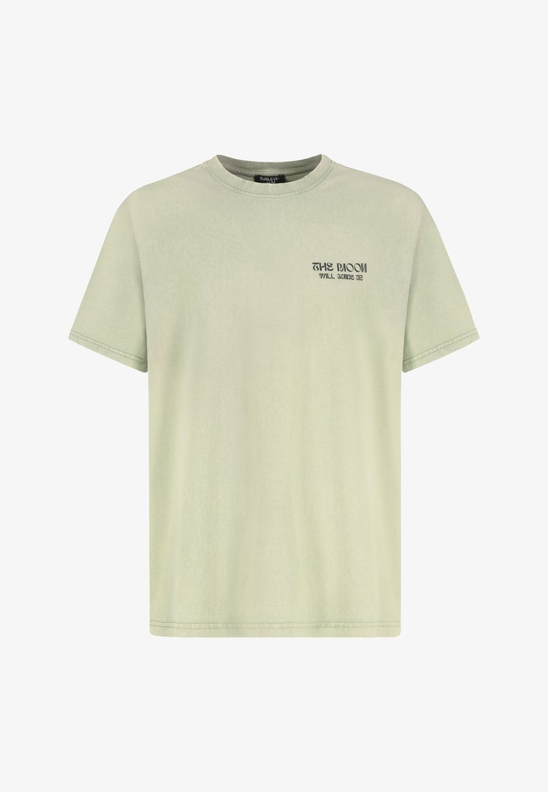 Light green cotton T-shirt with short sleeves, crew neck, and a small black graphic text on the front. Smooth texture, relaxed fit.