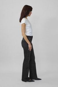 Black flared jeans made of denim, featuring a high waist and subtle pockets, paired with a fitted white t-shirt. Side profile view.