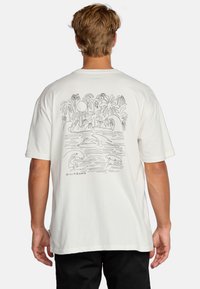 White cotton t-shirt featuring a black line drawing of surfers and palm trees on the back. Short sleeves, relaxed fit, and no patterns.