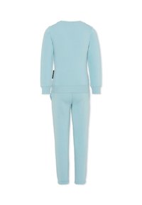 Survêtement bleu clair en tissu doux ; il présente des manches longues et un pantalon ajusté avec des poignets ; design simple sans motifs ni accents supplémentaires.