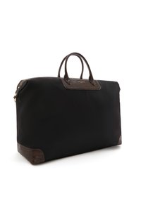 Schwarze Nylon-Reisetasche mit braunen Lederelementen, ausgestattet mit doppelten runden Griffen, rechteckiger Form und einem strukturierten Muster auf dem Leder.