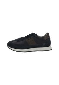 Zapatilla negra de caña baja con franjas laterales marrón oscuro, suela blanca y cierre de cordones negro, vista de lado.