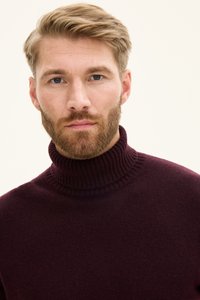 Bordeauxroter Rollkragenpullover mit geripptem Ausschnitt; aus einem weichen, strukturierten Material gefertigt, mit figurbetontem Schnitt und glattem Finish.