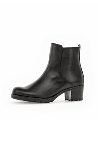 Botte chelsea en cuir noir avec un talon bloc et un bout rond, dotée de panneaux élastiques sur les côtés et d'une languette à l'arrière.
