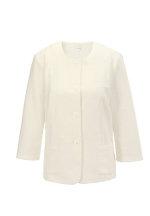 Veste blanche à texture avec un col rond, des manches trois-quarts et une fermeture par boutons sur le devant. Dotée de deux poches à rabat sur les côtés.