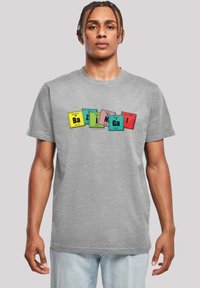 Gray cotton t-shirt featuring a colorful graphic print with periodic table elements. The text "Bazinga!" is prominently displayed in various colors.