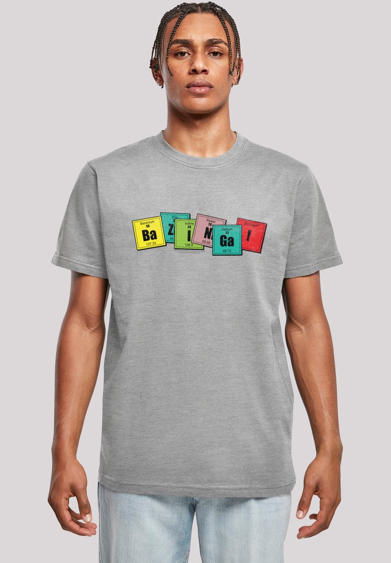 Gray cotton t-shirt featuring a colorful graphic print with periodic table elements. The text "Bazinga!" is prominently displayed in various colors.