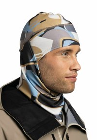 Mehrfarbige Balaclava mit abstrakten Formen in Beige, Blau und Schwarz. Hergestellt aus elastischem Stoff, der für eine enge Passform und Komfort sorgt.