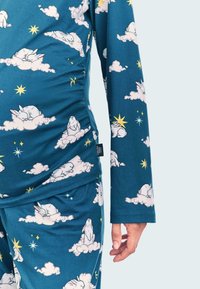 Teal pajama set featuring a pattern of white rabbits on clouds and yellow stars. Made of soft fabric with long sleeves and elastic ruching.