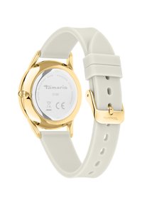 Runde Uhr mit einem Gehäuse aus goldfarbenem Edelstahl und einem weißen Silikonarmband. Wasserdicht bis 3 ATM, mit gravierten Details auf der Rückseite.