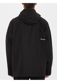 Czarna, bawełniana kurtka z kapturem o luźnym kroju. Posiada akcent z logo na lewym ramieniu oraz gładką teksturę. Idealna na codzienne noszenie.