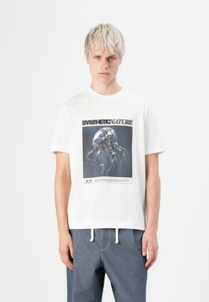 White cotton t-shirt featuring a graphic design of a jellyfish against a dark background, with the text “SYNTH-ETIC NATURE” above it.