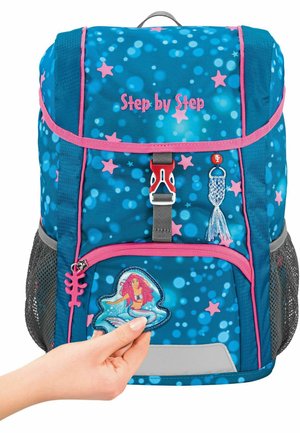 Blue backpack with pink accents, patterned with stars and bubbles. Features include a mermaid patch, mesh side pockets, and a top handle.