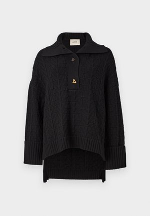 Black knitted pullover with a textured pattern, high collar, and button closure. Ribbed cuffs and hem, featuring a triangular gold accent.