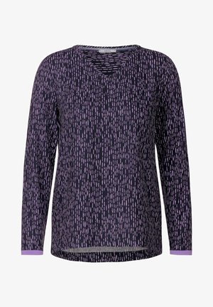 Langarmshirt mit tiefem V-Ausschnitt, aus dunkelpurpurfarbenem Stoff mit einem verstreuten hellpurpurfarbenen Muster. Weicher Stoff mit kontrastierenden Bündchen.