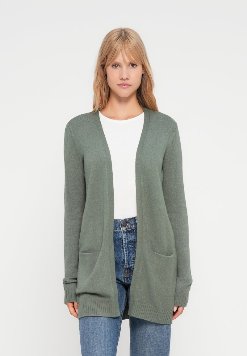 Ljusgrön cardigan med avslappnad passform, med långa ärmar, öppen front och två framfickor. Tillverkad av mjukt, texturerat stickat tyg.