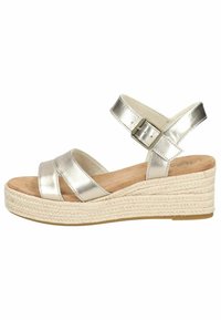 Metallic silver wedge sandals with two crossed straps, adjustable ankle buckle, and a jute-wrapped platform. Soft insole for comfort.