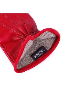 Rote Lederhandschuhe mit einer glatten Oberfläche, dekorativer Naht und einem weichen Wollfutter. Enthält ein Etikett innen mit "ROECKL".