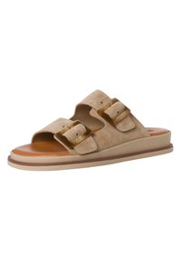 Beige suede slide sandals with two large, rectangular tortoiseshell buckles and a brown cushioned insole. Flat, rubber sole.