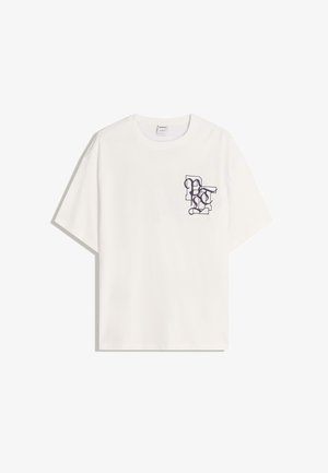 Witte katoenen t-shirt met korte mouwen, een ronde halslijn en een paarse grafische print op de linker borst.