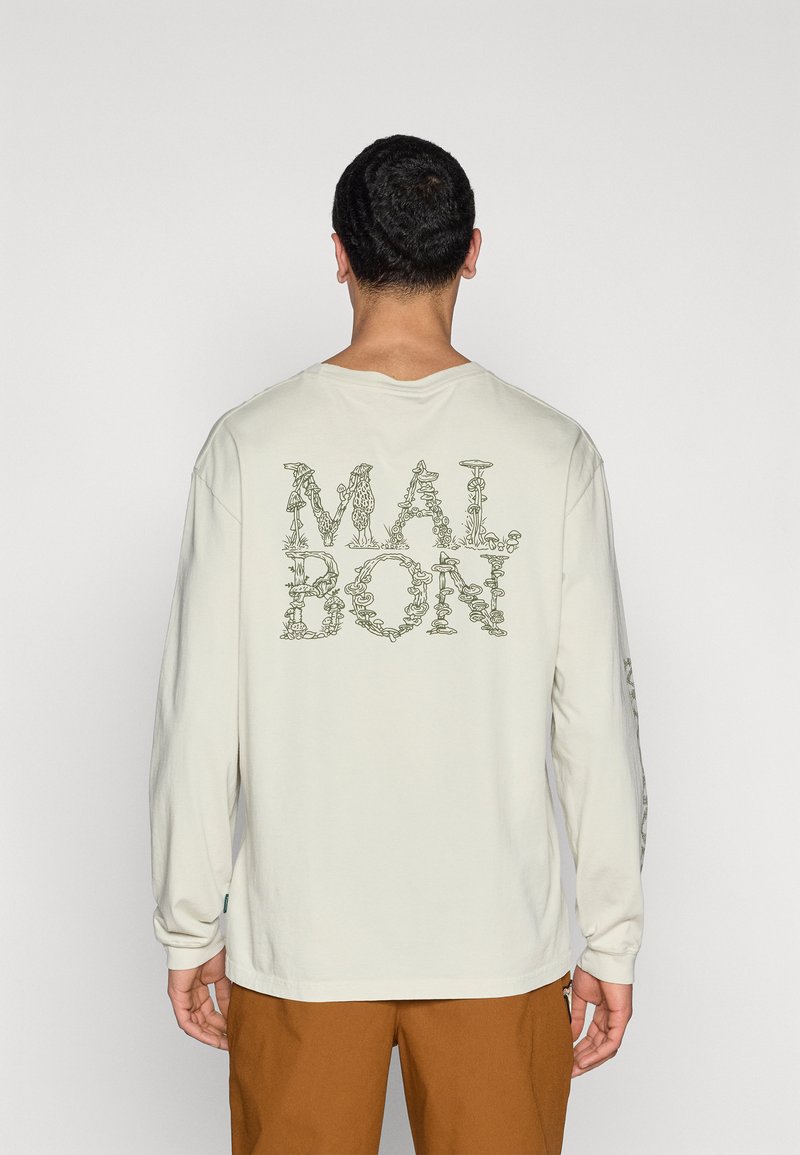 Light beige long-sleeve shirt with "MALBON" text design on the back in green. Features a relaxed fit and ribbed neckline.